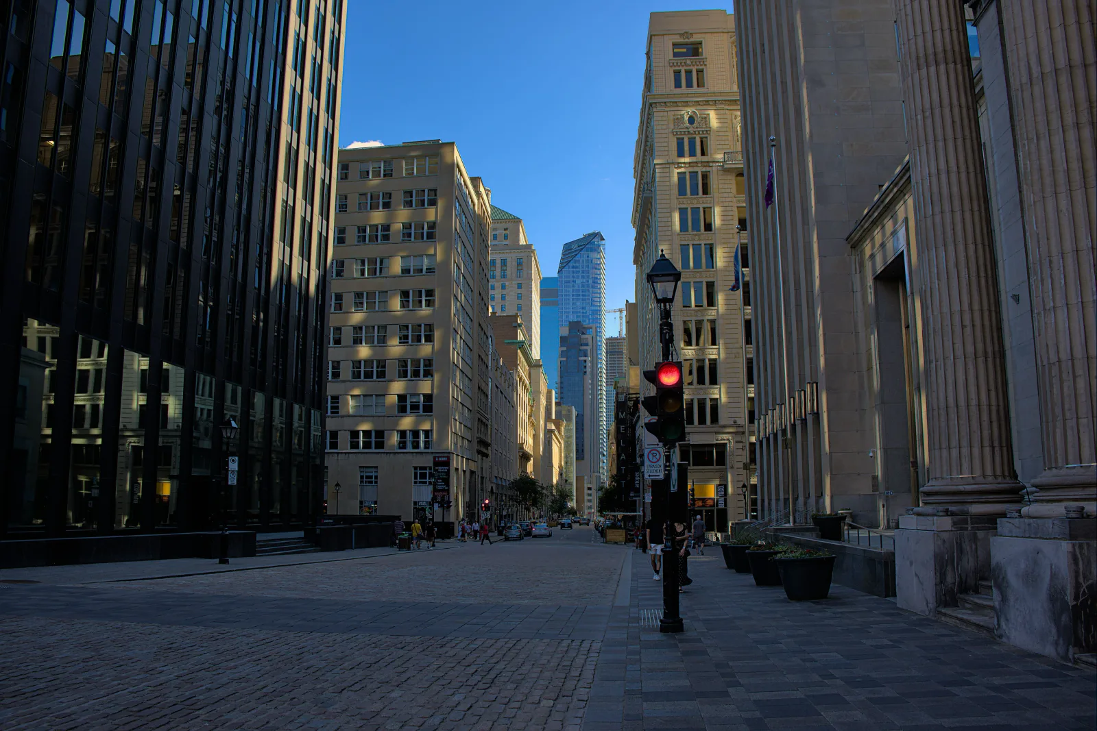 A business street in morning light, with office frontages along the pavement