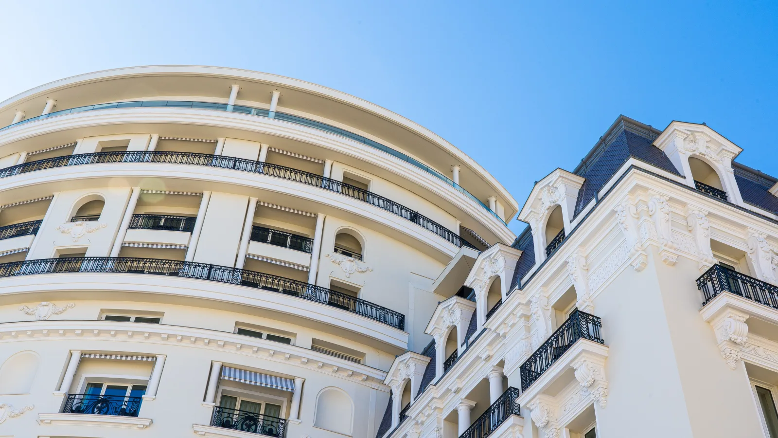 Residential facades with balconies on a hillside street